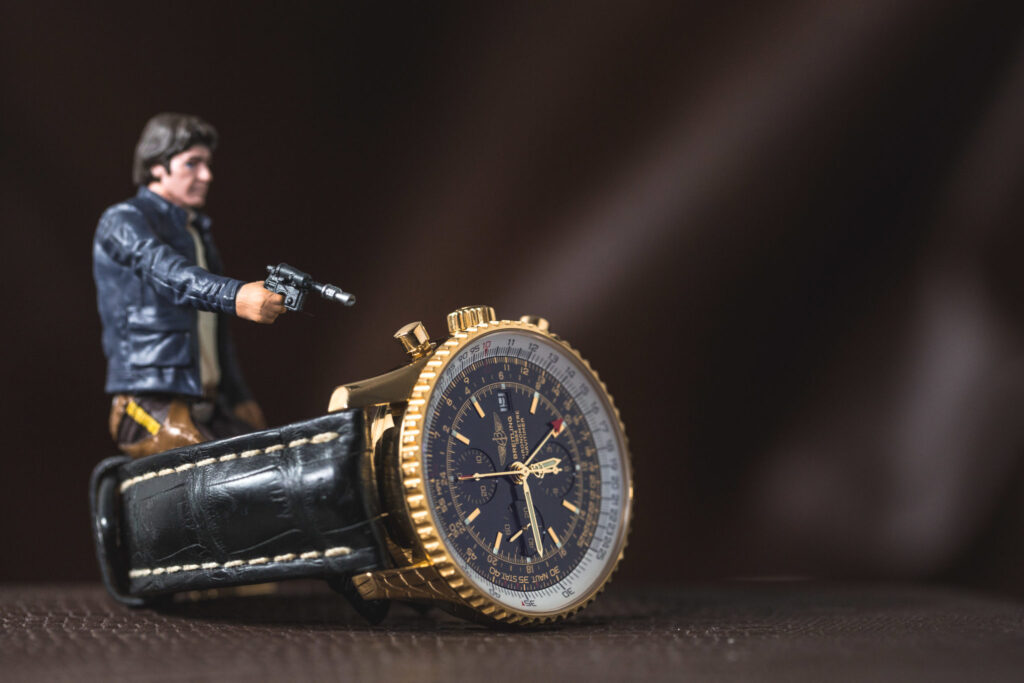 An image of a Han Solo figurine with a Breitling Navitimer 