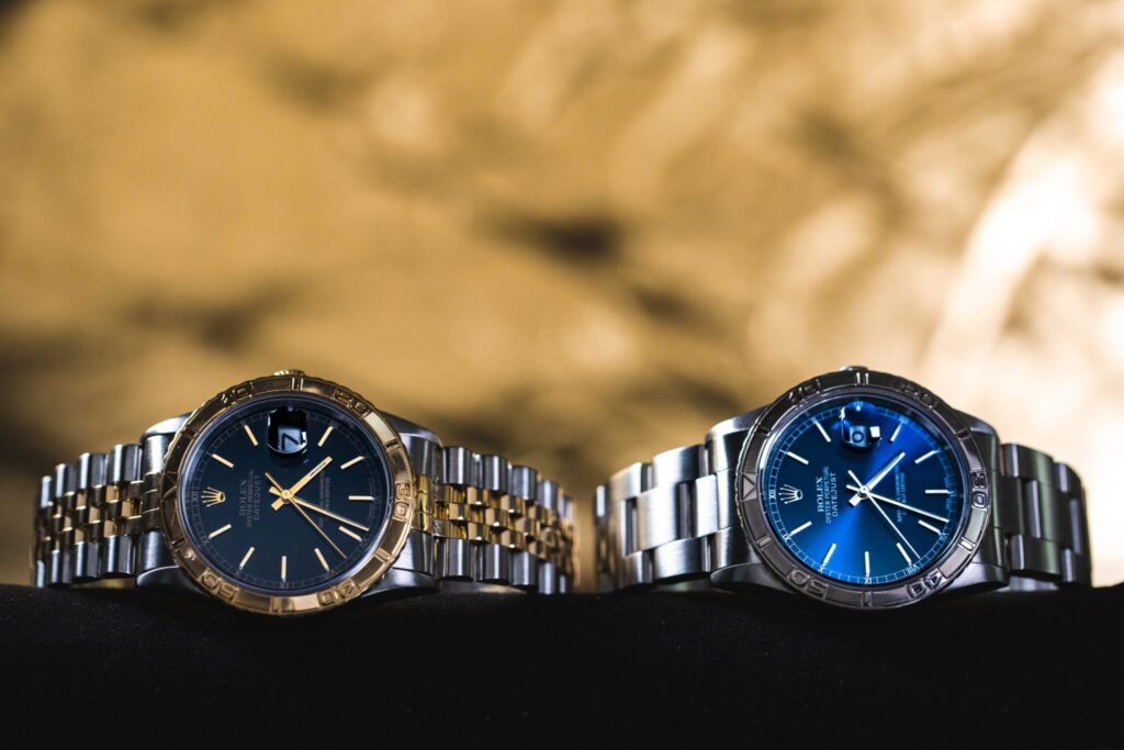 A pair of Rolex Turn-O-Graphs on their sides 
