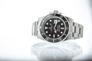 Rolex Submariner reflecting on white surface